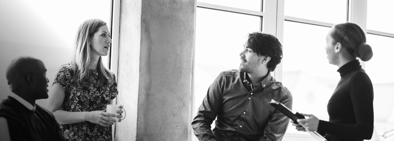 A group of people joined together and talking.