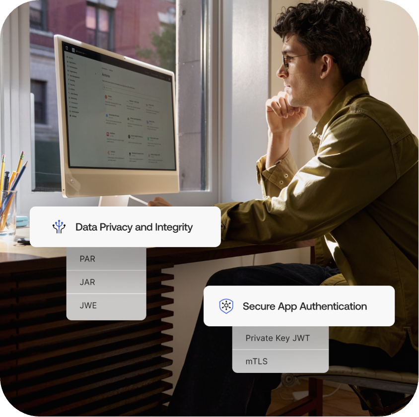 Man smiling at computer monitor, adjusting data privacy settings