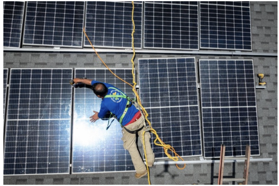 A man installs solar panels