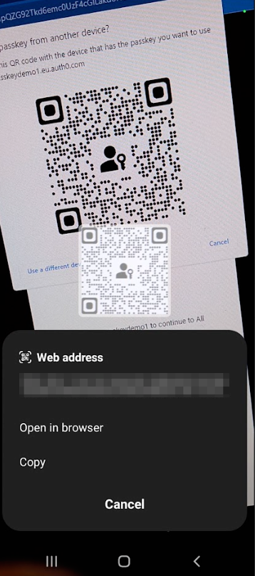 A smartphone screen displays a QR code for authentication, with a web address prompt at the bottom. 